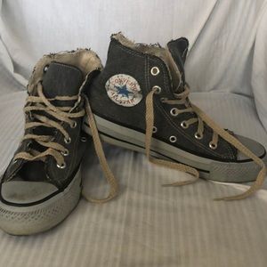 Gray high top converse with hemp laces.